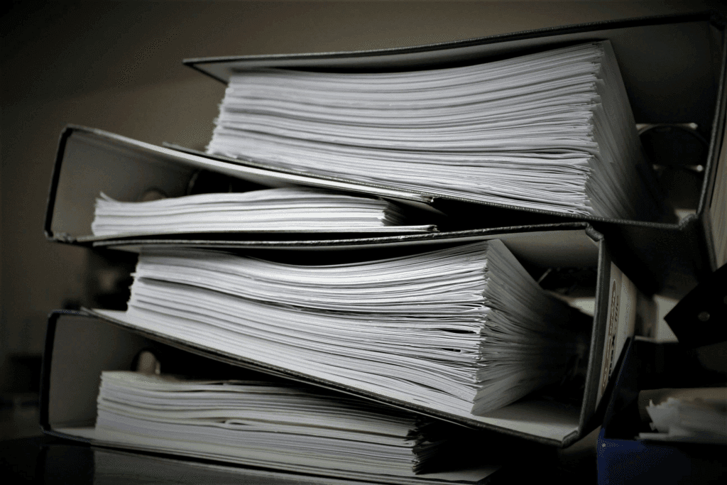 Stack of legal documents organized in binders.