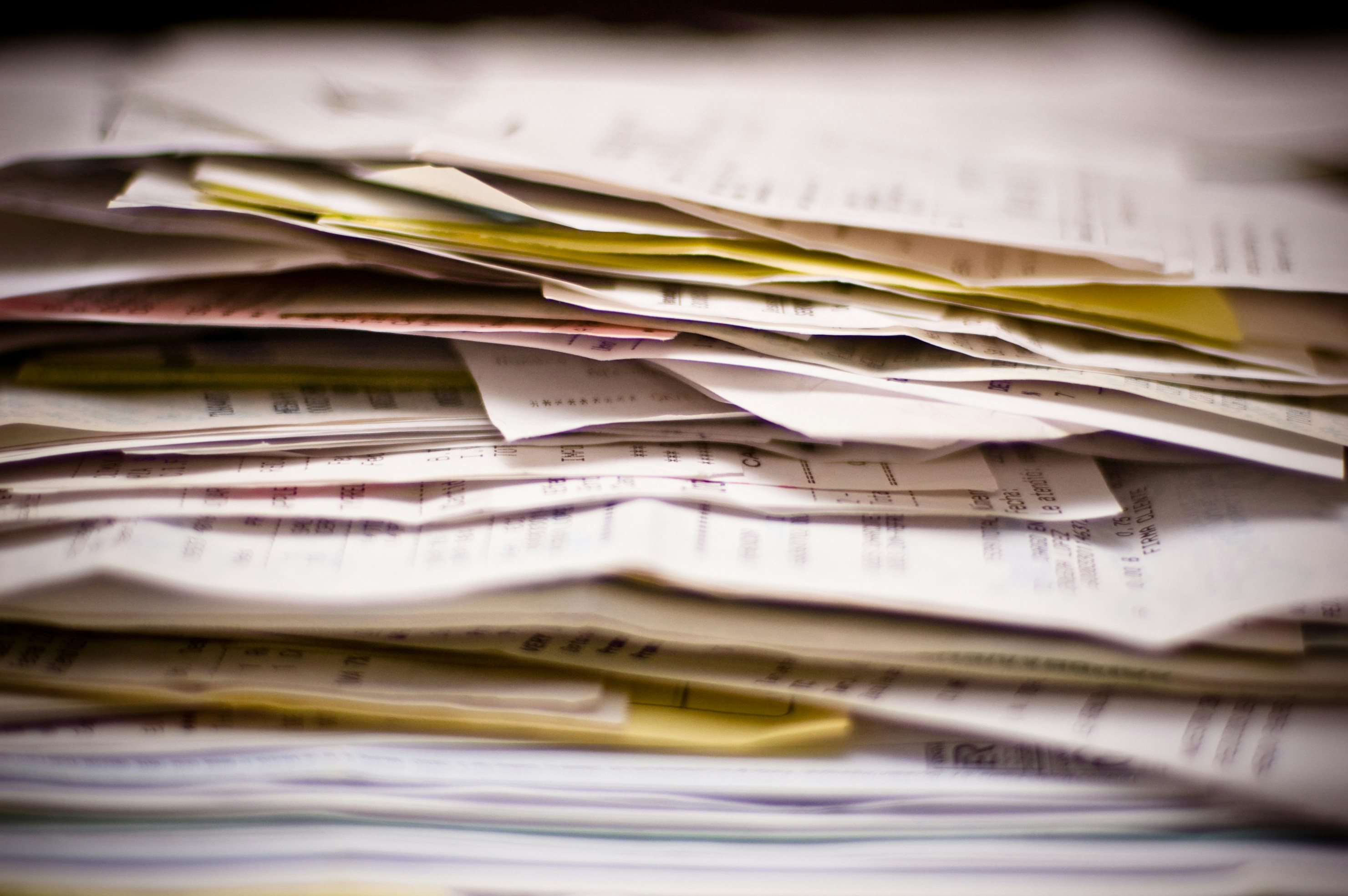 Business compliance paperwork and legal documents arranged on an office desk.