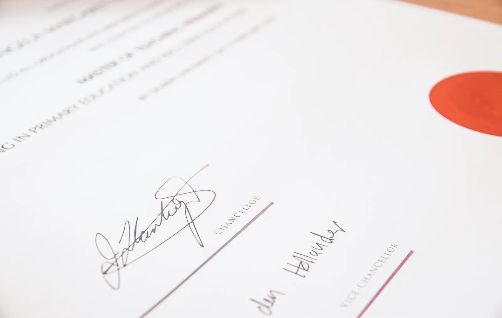 Close-up of a signed document with signature lines and official titles