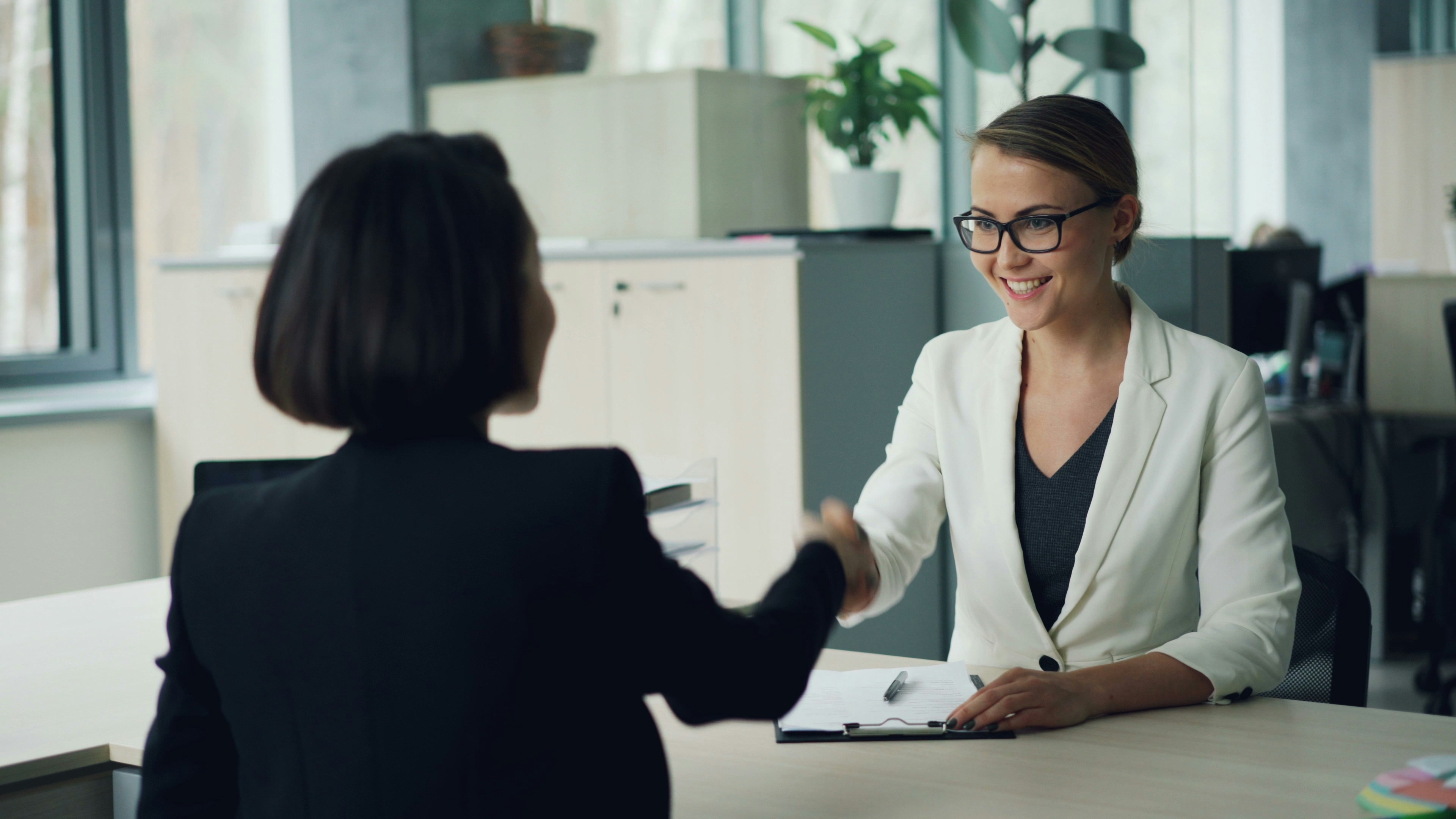 Candidate and hiring manager shaking hands after an internship interview.