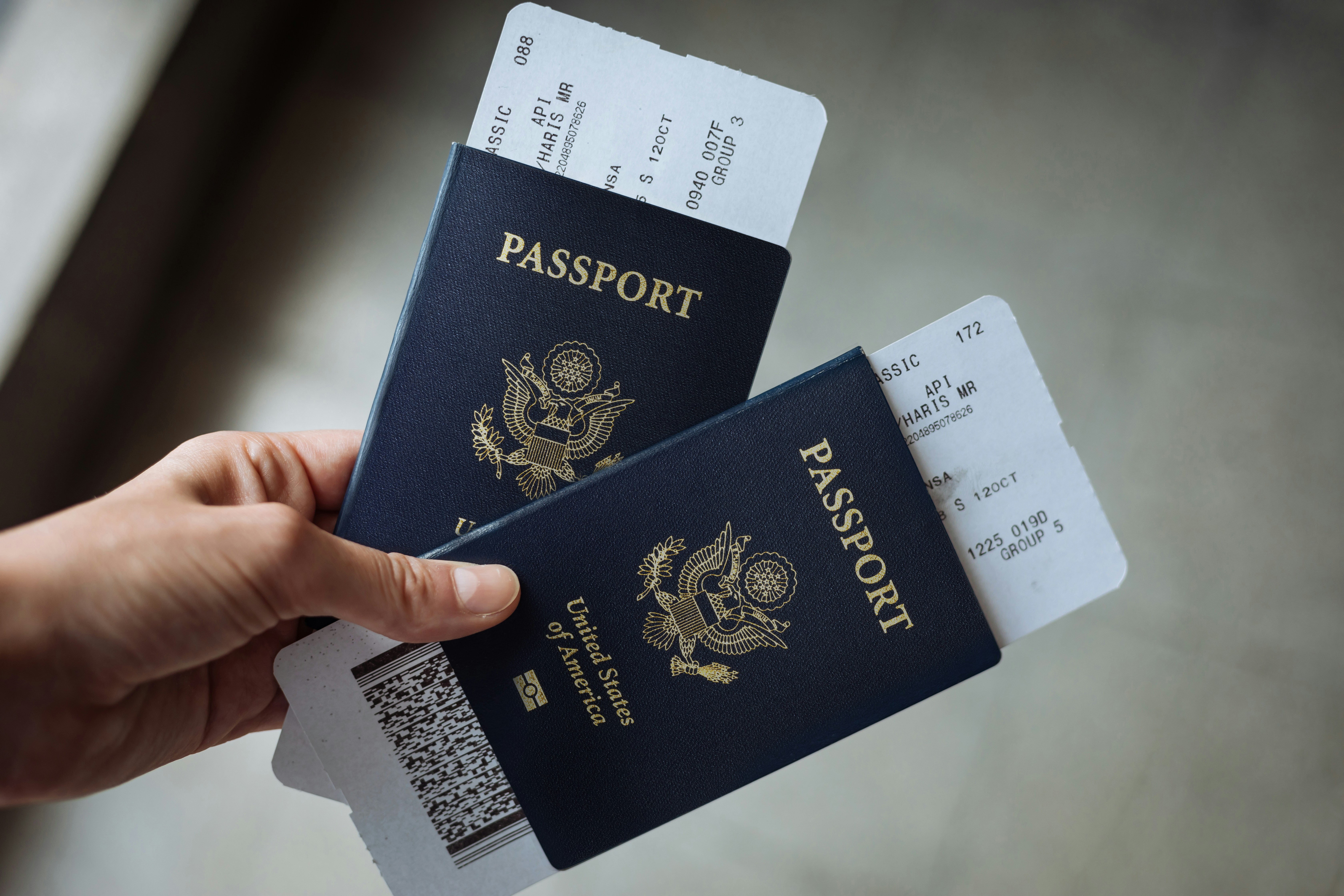 Passports and flight tickets in hand, organizing documents for the immigration process
