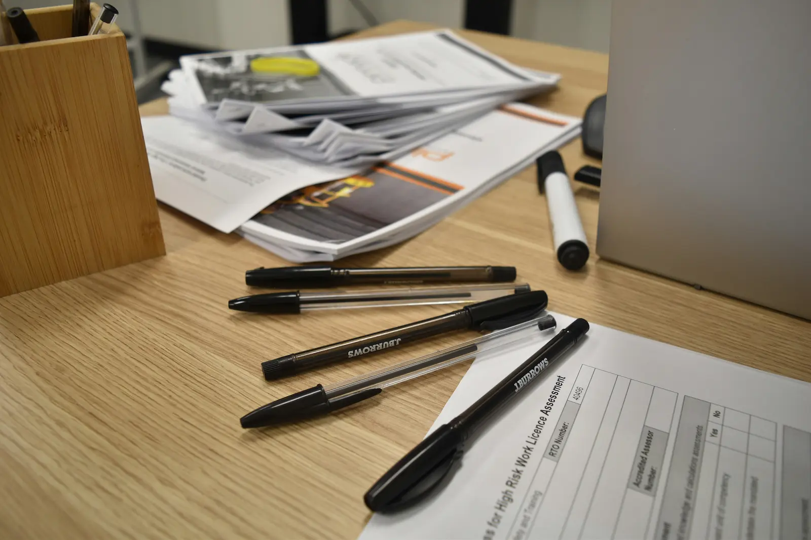 Documents laid out with pens for a self-prepared green card application package