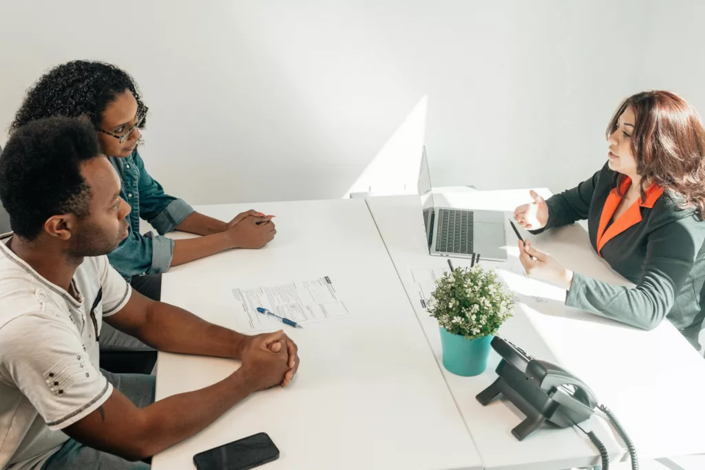 Lawyer consulting clients about legal documents.