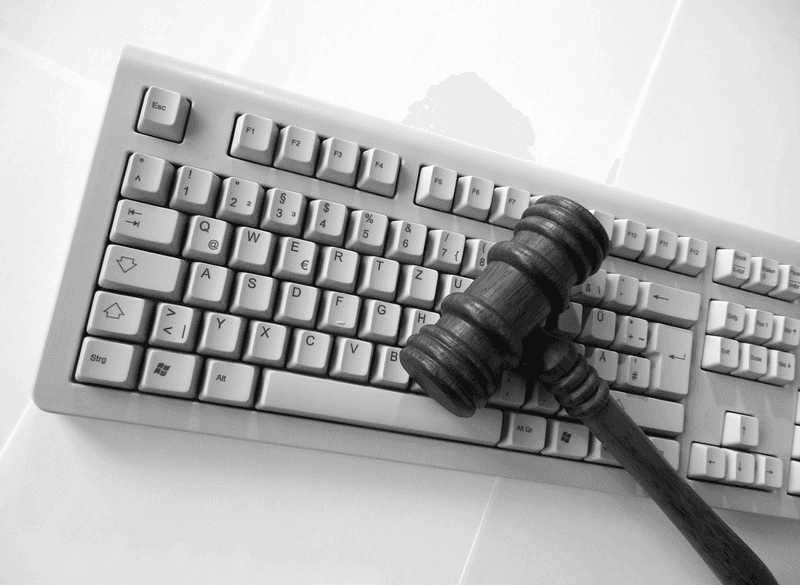 Judge’s gavel on a computer keyboard.