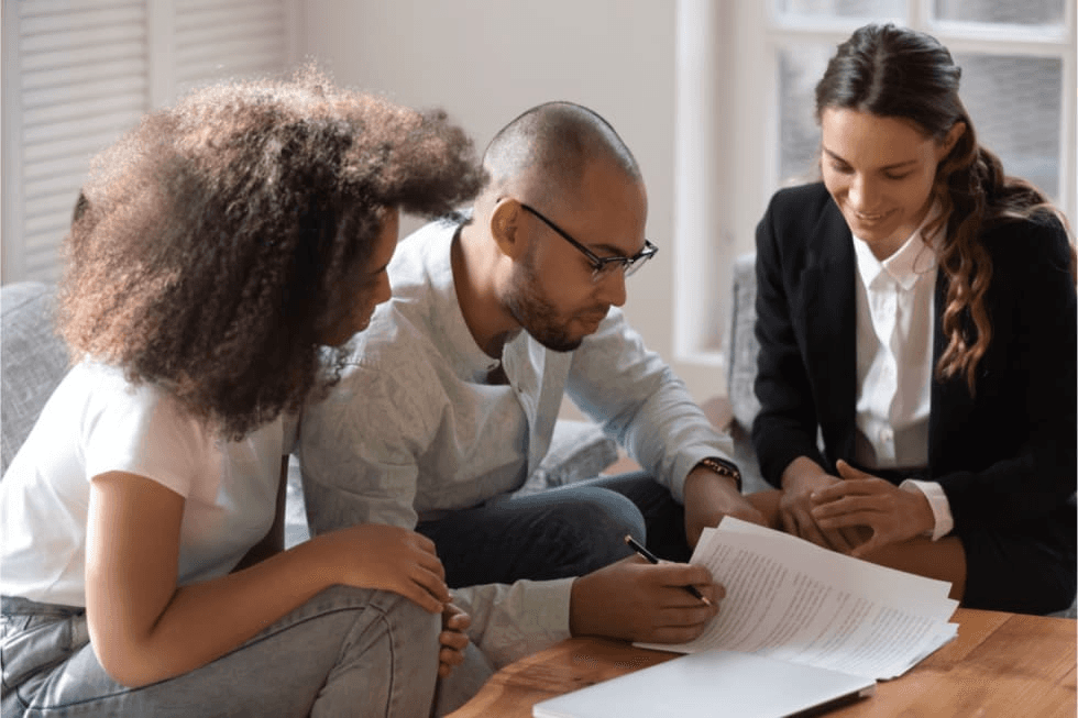 Landlord and tenant reviewing a lease agreement and legal documents
