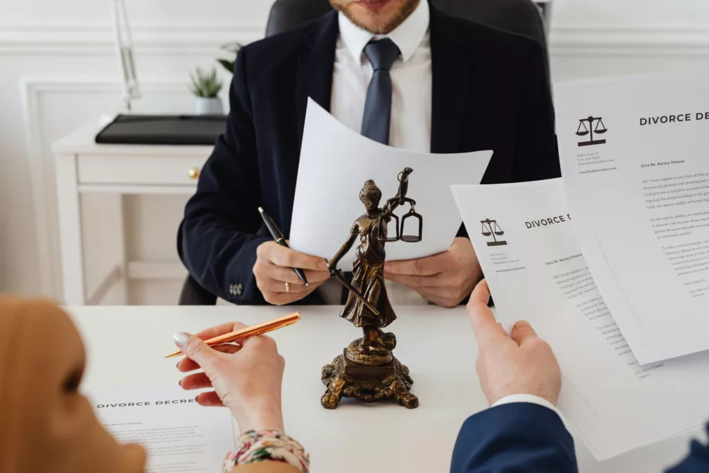 Lawyer discussing divorce decree documents with clients.