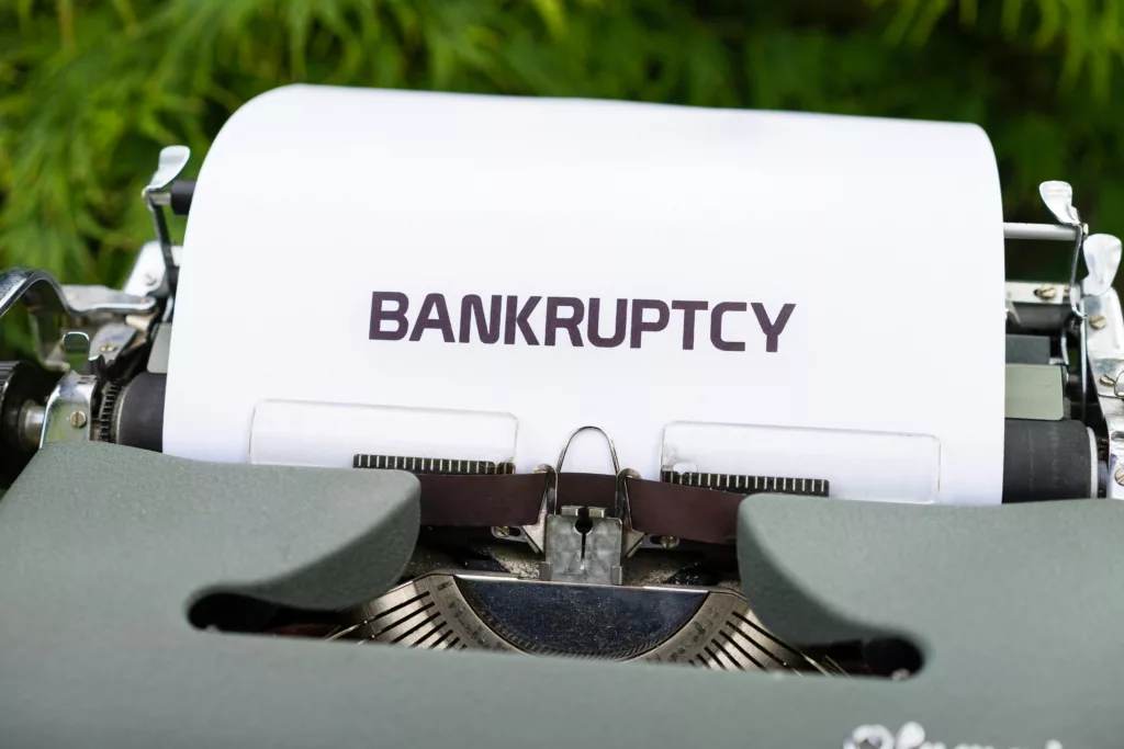Paper with the word 'Bankruptcy' typed on a typewriter.