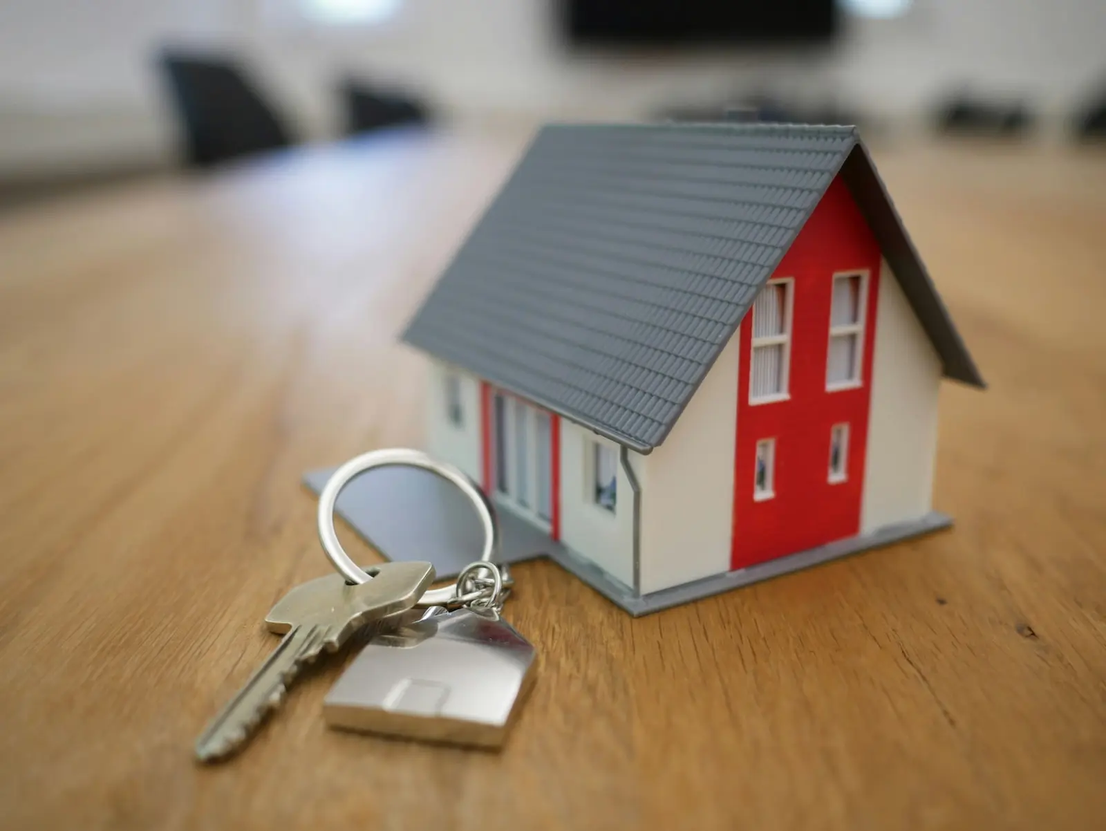 House keys and a model house on a table