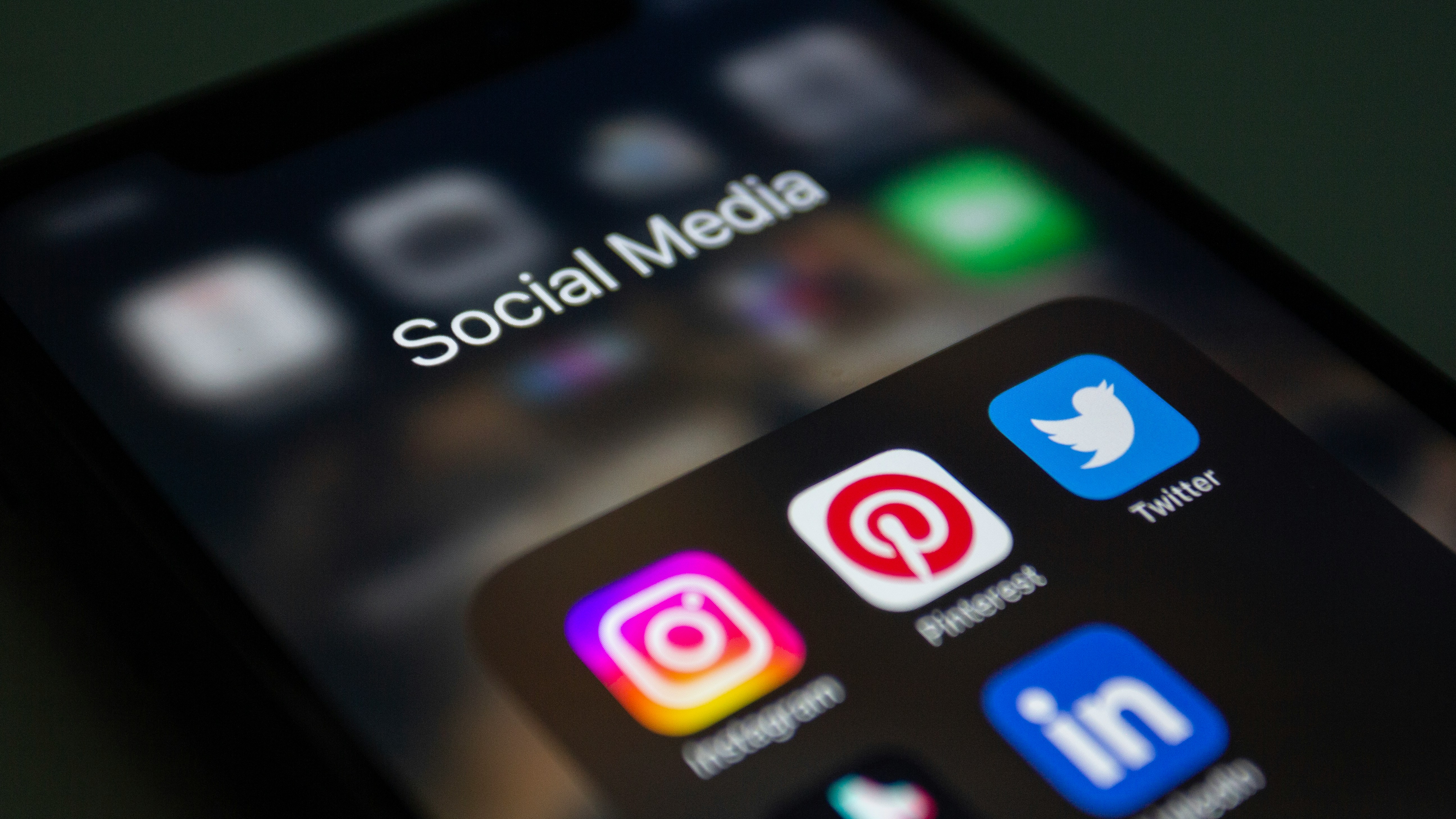 Close-up of a smartphone screen showing a social media folder with app icons.