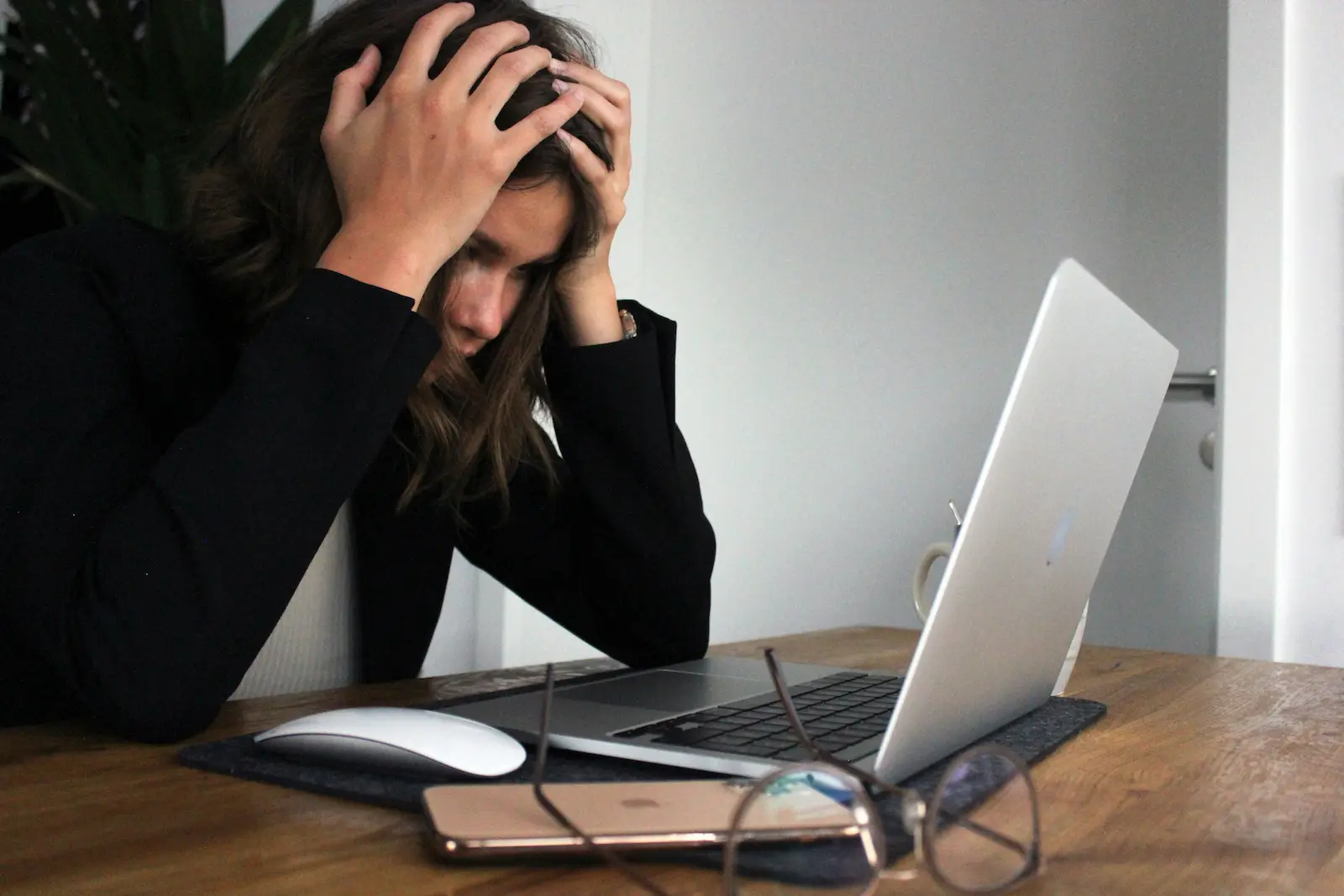 Stressed woman working on DUI case letters at her laptop